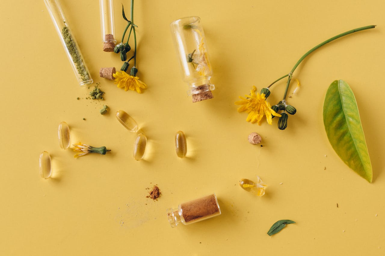 Mastering the First Impression: Your intriguing post title goes here A flat lay of glass bottles, capsules, and flowers on a vibrant yellow surface, representing natural remedies.